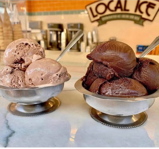 Two silver dishes of chocolate ice cream under the Local Ice sign.
