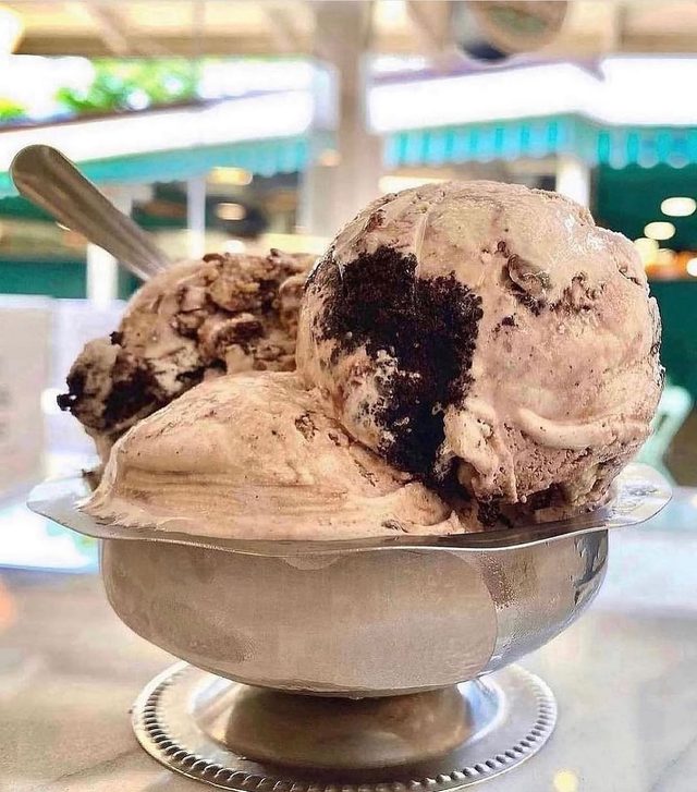 A silver dish of cookies and cream scoops.